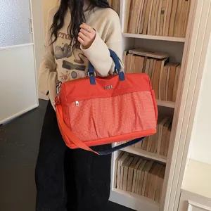 Large capacity travel duffel bag for women, lightweight overnight weekender bag with pockets.