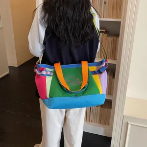 Korean style large capacity color block canvas shoulder tote bag for casual travel commute.