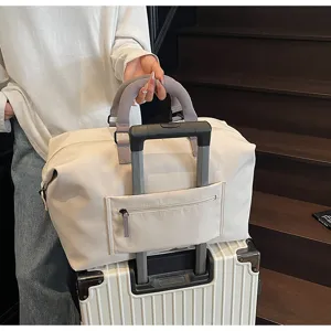 Beige travel duffel bag detail, large capacity luggage bag with trolley sleeve and pockets.