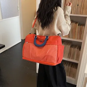 Large capacity travel duffel bag for women, lightweight canvas shoulder handbag daily use.