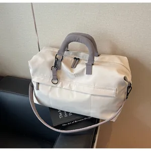 Travel duffel bag detail showcasing sturdy handles, durable zipper, and spacious interior design.