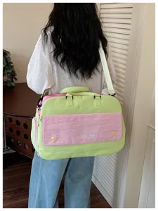 Colorblock travel duffel bag for women, large capacity shoulder gym bag for short trips.