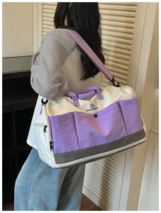Large capacity travel duffel bag with multiple pockets and purple details for short trips.