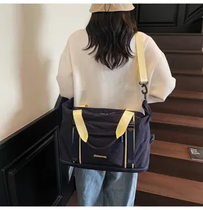 Vista detallada de la gran bolsa de viaje con correas de hombro resistentes y tela azul.