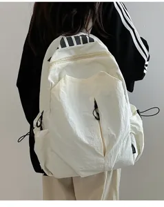 Casual waterproof white backpack for students and outdoor travel with large capacity design.