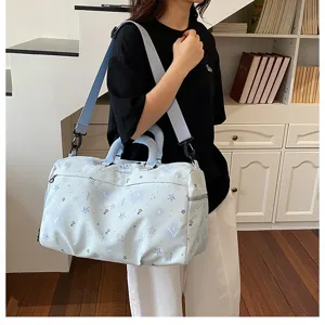 Detailed view of the light blue starry print travel duffel bag with spacious interior.
