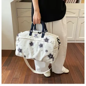 Close-up view of the travel duffel bag featuring star pattern and sturdy dual handles.