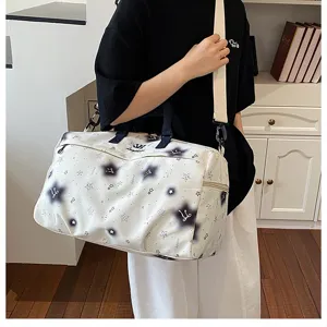 Detailed view of the large capacity travel duffel bag with stylish star pattern for women.