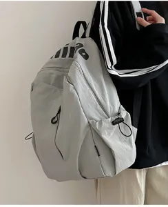 Lightweight water-repellent large capacity grey casual backpack for daily outdoor travel use.