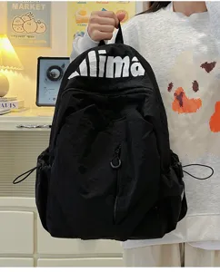 Detail view of black lightweight water-resistant casual backpack with white letters print.