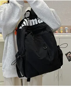 Water-repellent black backpack detail, large capacity outdoor sports rucksack with letter print.