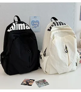 Detail view of casual black and white backpacks, featuring front zipper and top print.