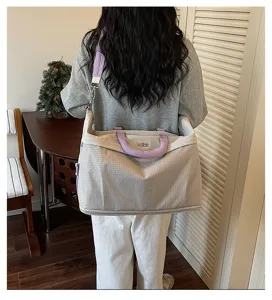 Grande borsa da viaggio capiente con tracolla e manico viola elegante per il weekend.
