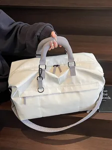 Large capacity travel duffel bag for women, stylish weekend overnight luggage with shoulder strap.
