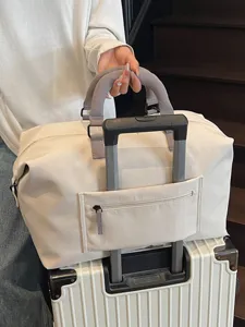 Large capacity travel duffel bag, casual overnight luggage bag with trolley sleeve on suitcase.