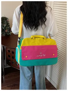Colorful color block travel bag detail, spacious shoulder bag showing back view design.