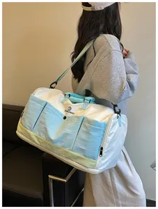 Large capacity travel duffel bag detail, multi-pocket design, stylish for sports.