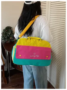 Color-blocking duffel travel bag detail showing vibrant multi-color design and large capacity.