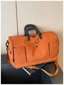 Large capacity travel duffel bag with multiple pockets, durable orange canvas for sports.