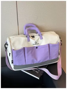 Large capacity travel duffel bag detail, stylish purple and white sports gym bag with pockets.