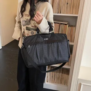 Large capacity travel duffel bag for women and men, lightweight gym sports bag with grid pocket.
