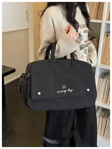 Casual black travel duffel bag with large capacity, shoulder strap and handbag design.