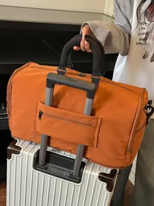 Large capacity travel duffel bag with trolley sleeve portable orange weekend gym bag
