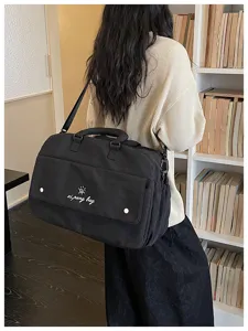 Casual black travel shoulder bag for women, large capacity lightweight gym and sports duffel bag.