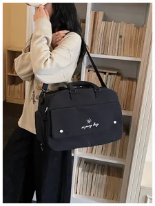 Black large capacity travel duffel bag for women, lightweight casual weekender bag with shoulder strap.