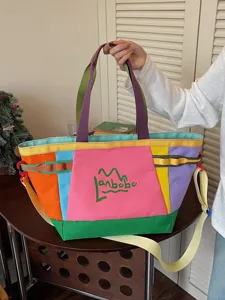 Colorful canvas tote bag with large capacity, ideal for outdoor travel and daily commuting.