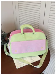 Detailed view of the color block travel bag, spacious capacity, sturdy handles and straps.