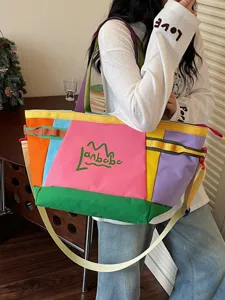 Color-block canvas tote bag, large capacity travel shoulder bag, casual commuting handbag.