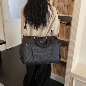 Large capacity travel duffel bag with grid pattern, stylish shoulder bag for trips.
