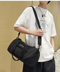 Black cylinder duffel bag for men and women, large capacity sports gym bag with strap.