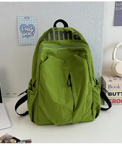 Lightweight water-repellent green backpack with large capacity, ideal for students and travel.
