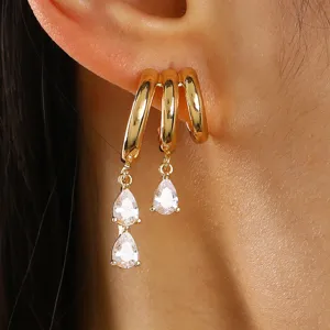 Close-up detail of a gold-plated multi-hoop earring with zircon teardrop tassels.