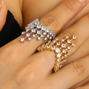 Detail showing intricate paved castle design on gold and silver architectural open rings