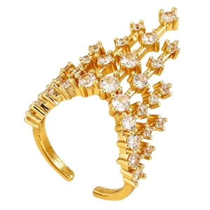 Detailed macro view of a gold castle-shaped open ring heavily inlaid with shiny crystals