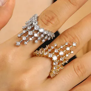Close-up detail of castle-shaped adjustable rings in silver and gold with sparkling crystals.