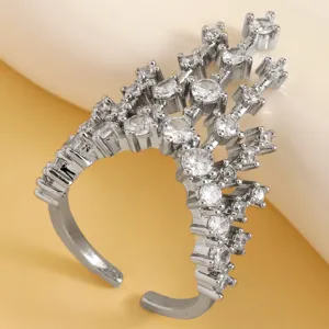 Close-up of a silver castle ring featuring paved sparkling zircons with adjustable band.