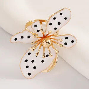 Detailansicht eines Retro-Blumenrings in Gold mit weißer Emaille und schwarzen Punkten