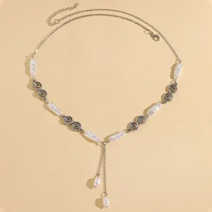 Detailed macro view of vintage silver chain necklace with pearls