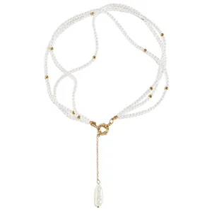 Detail showing multi-layered pearl necklace with golden OT clasp and baroque pearl pendant