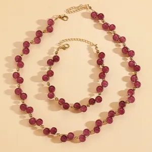 Vintage red round bead necklace and bracelet set with gold spacer beads detail view