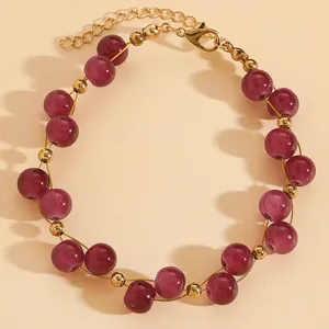 Detailed view of vintage beaded bracelet with purple beads and gold spacers