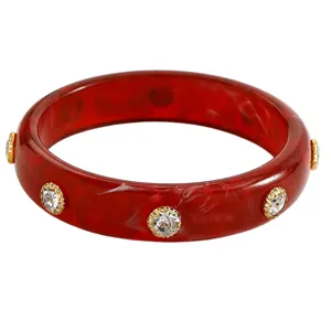 Macro view of a red marbled acrylic bangle bracelet with sparkling crystal studs