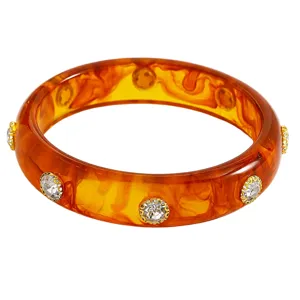 Detailed view of retro amber acrylic bangle bracelet with embedded gold crystal rhinestones