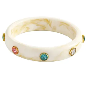 Close-up detail of retro acrylic wide bangle with colorful rhinestones.