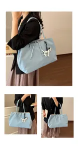 Large capacity shoulder tote bag with cute dog charm, stylish commuting handbag for women.