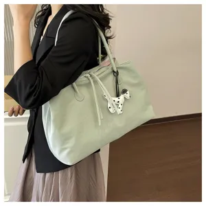 Large capacity green tote bag for women, stylish shoulder bag with cute dog charm for daily commute.